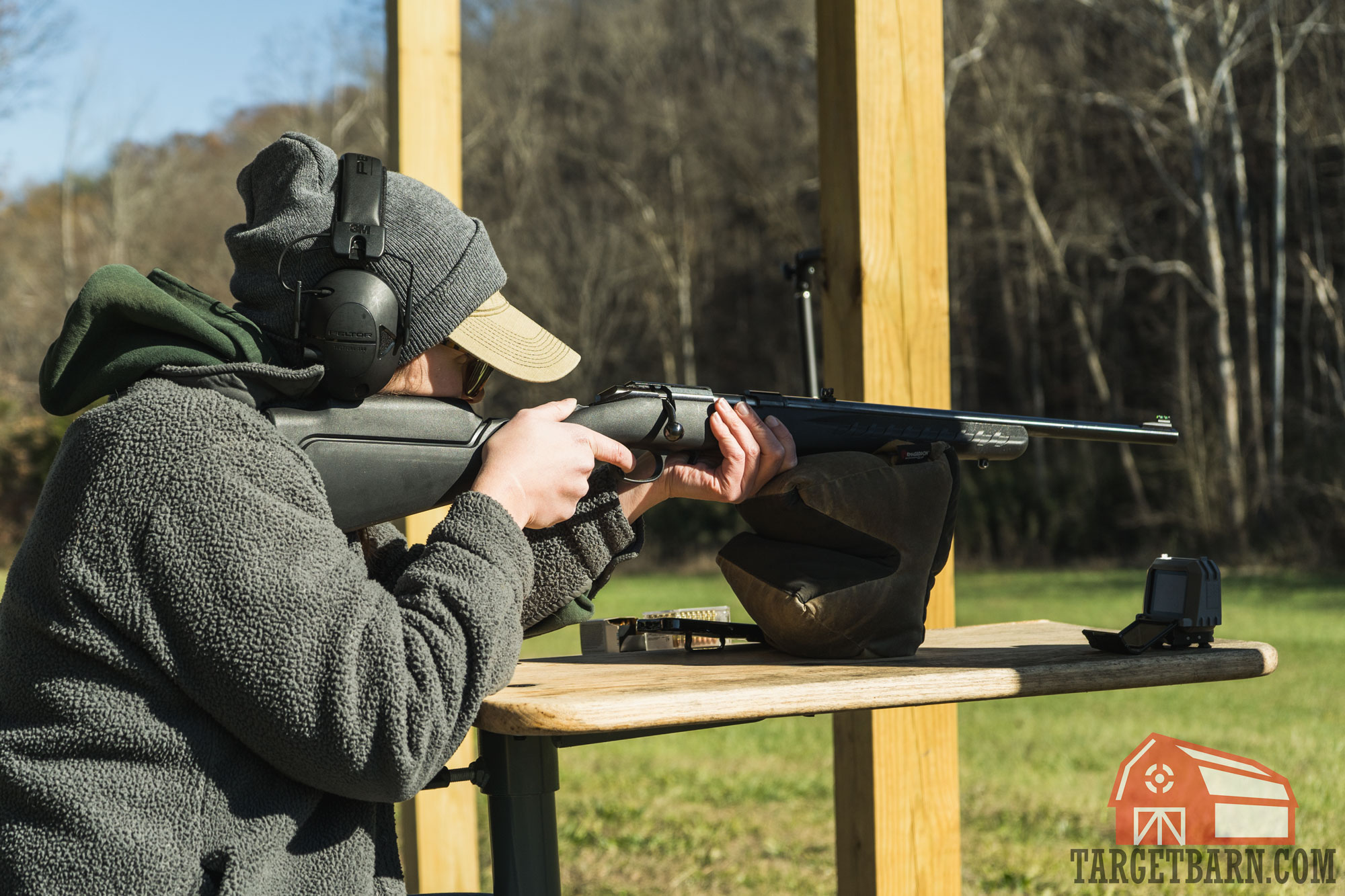 ruger american 22 mag a woman using a ruger american 22 magnum rifle to chronograph ammo at the range