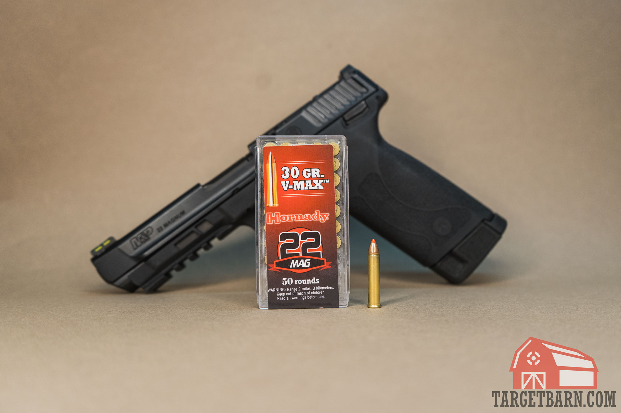 hornady 22 mag hornady v-max 22 wmr ammo infront of a smith & wesson m&P 22 magnum