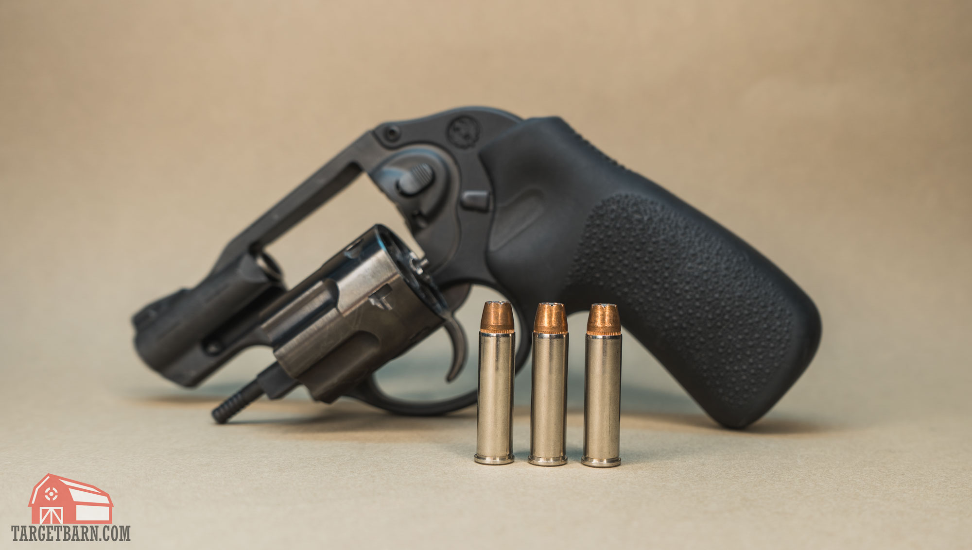 three rounds of .327 federal magnum ammo in front of a ruger lcr revolver