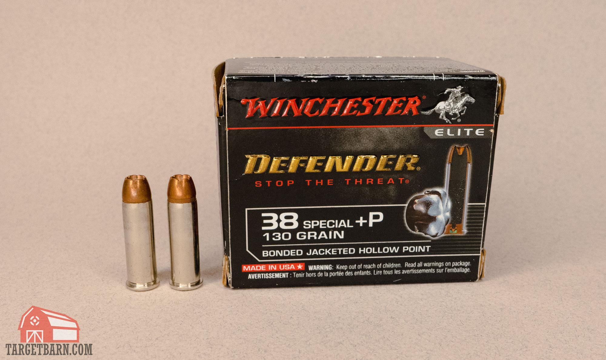 a box and two roudns of winchester defender 38 special jacketed hollow point rounds