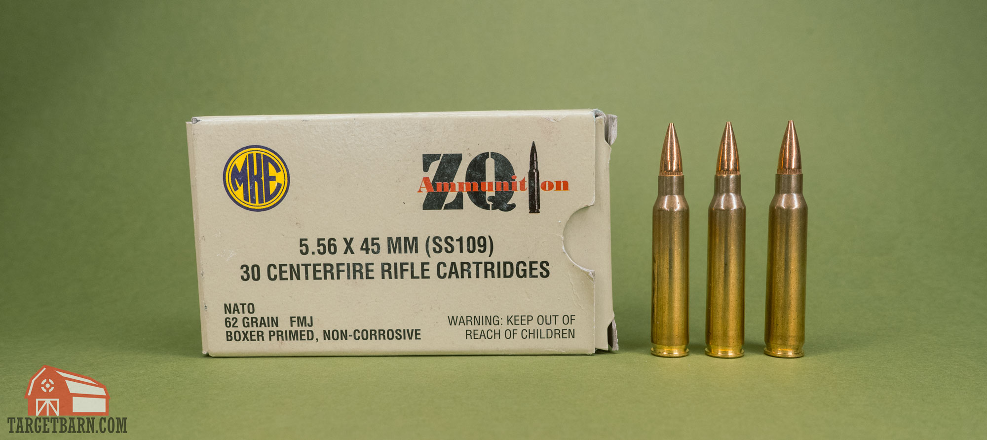 a box of zqui 5.56 nato ammunition and three rounds of 5.56