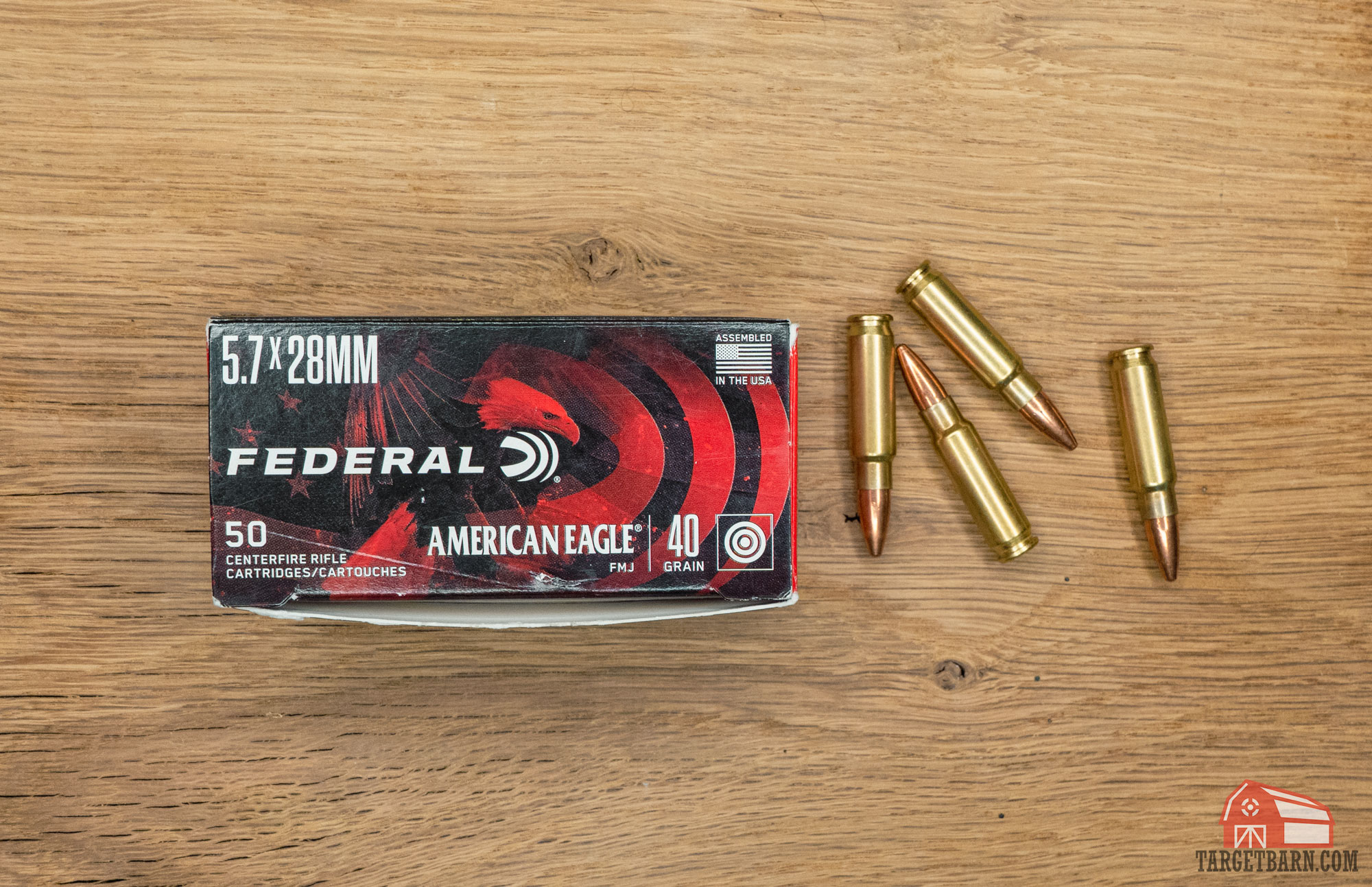 a box of federal 5.7x28mm ammo and loose 5.7 rounds