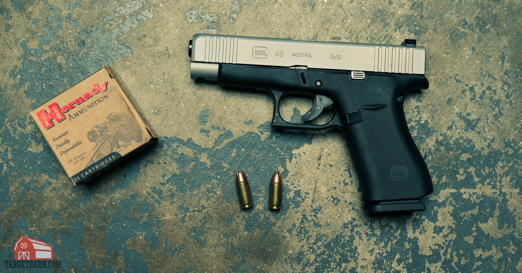 a glock 48 next to a hornady ammo box and two rounds of 9mm