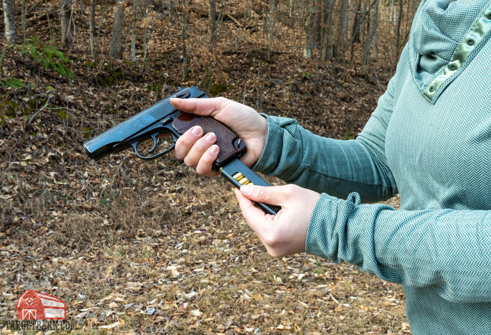 a woman loading a magazine into a 9mm makarov pistol