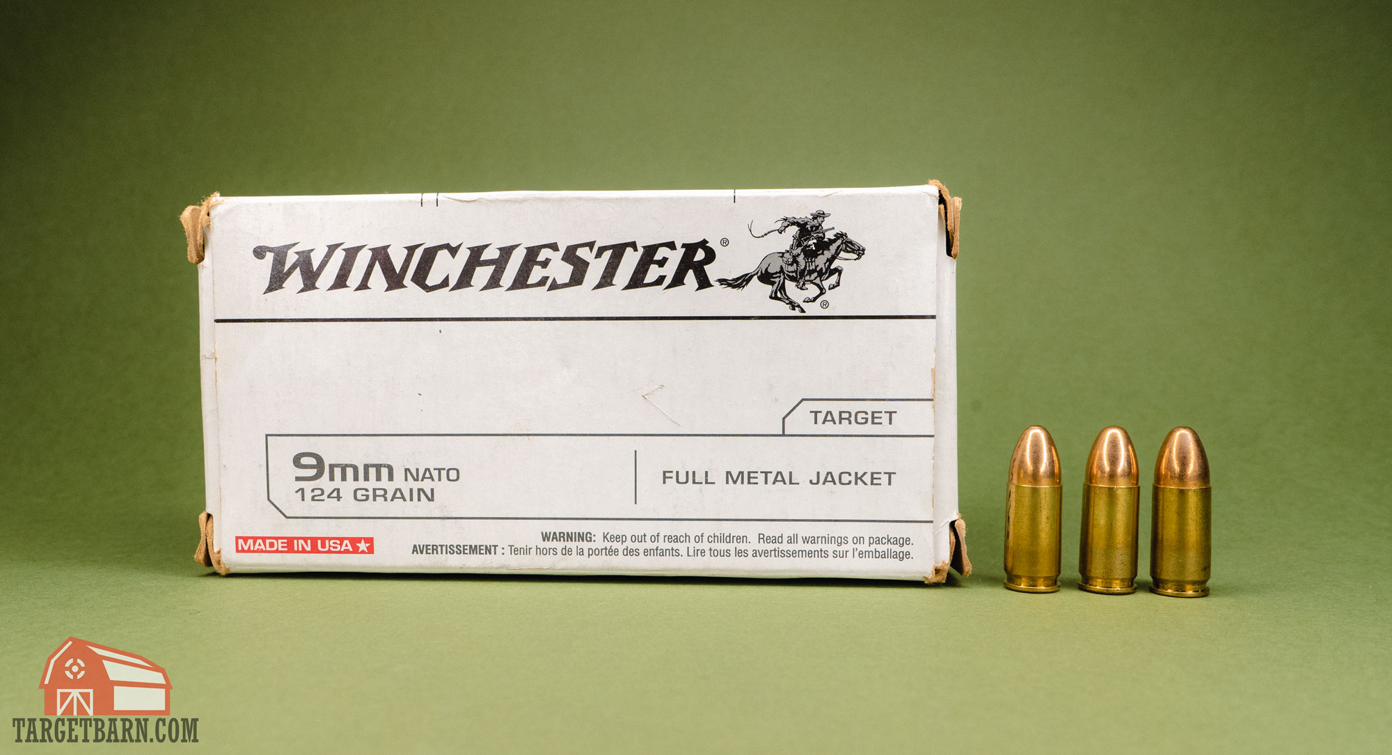 a box of winchester 9mm nato ammo with three rounds of 9mm