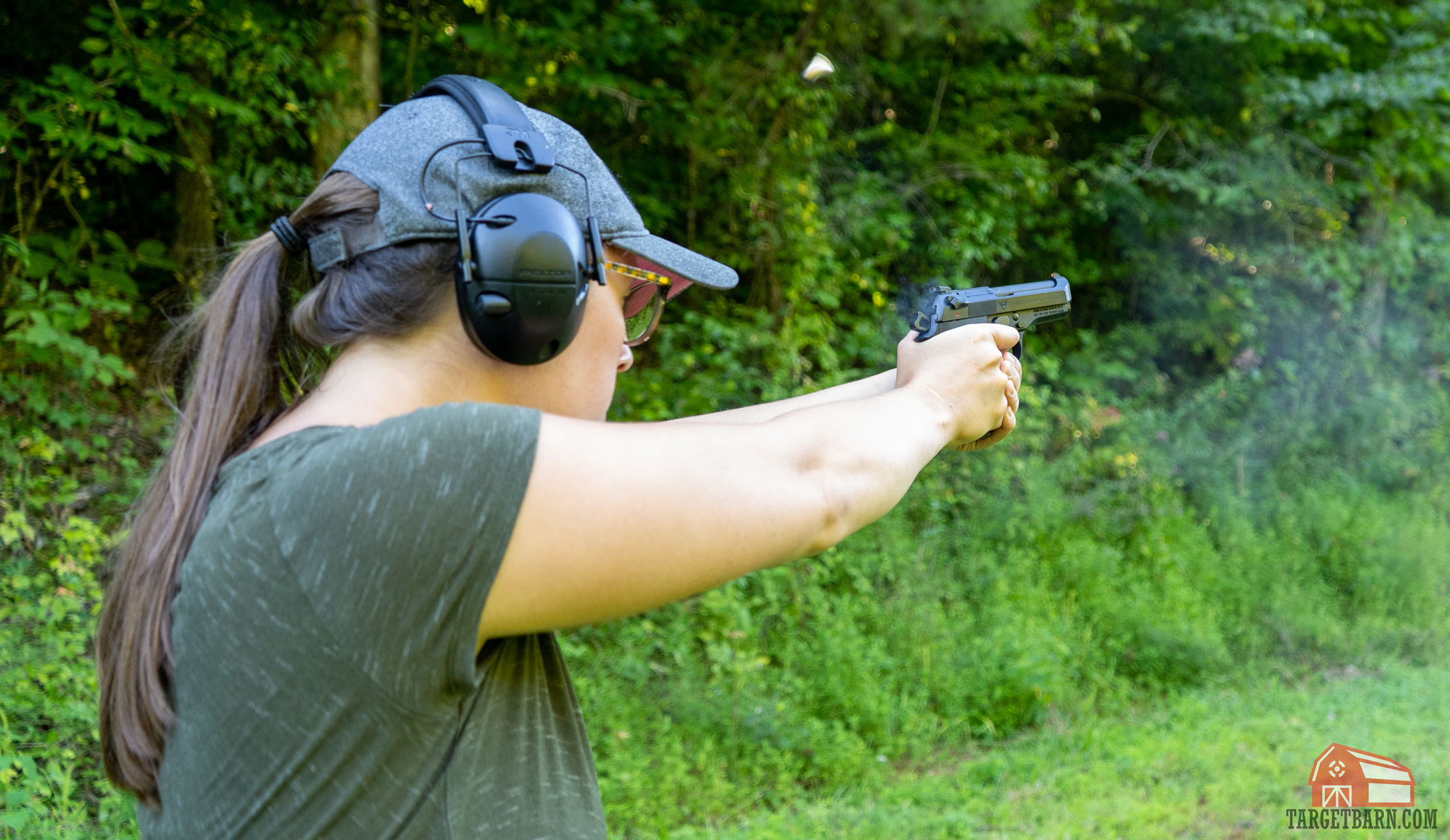 the author shooting a 9mm pistol with recoil