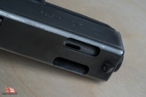 the front end of a gun with a ported barrel
