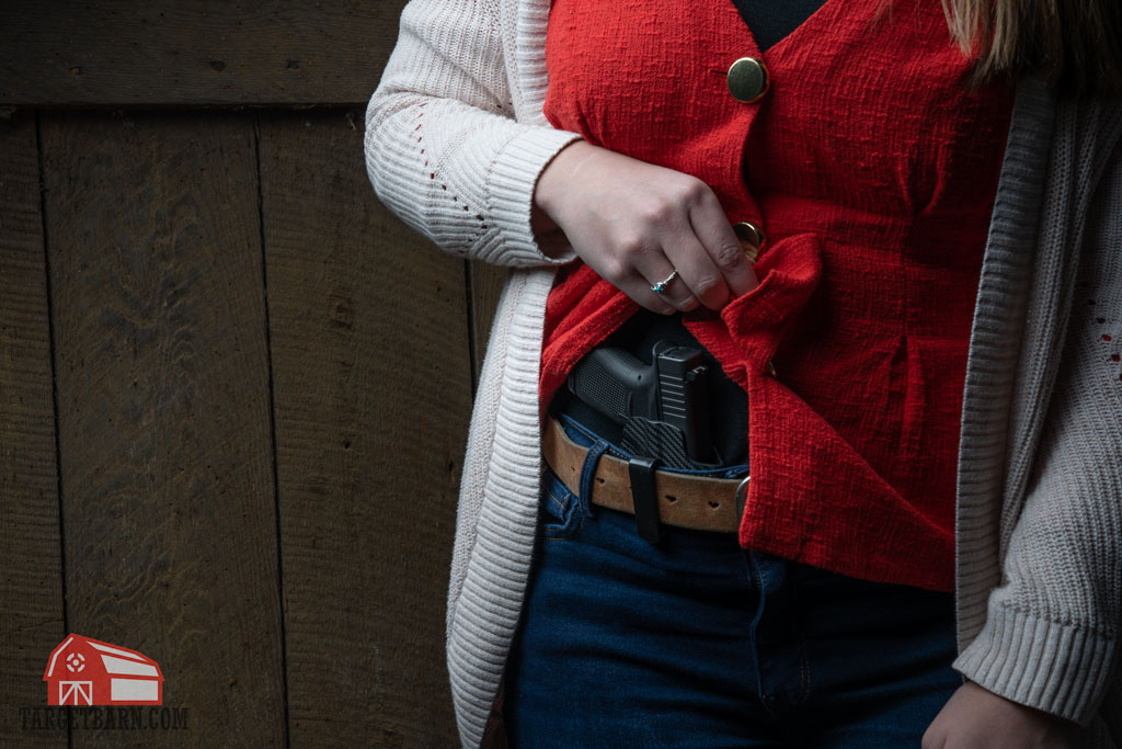 a woman conceal carrying a single stack glock pistol