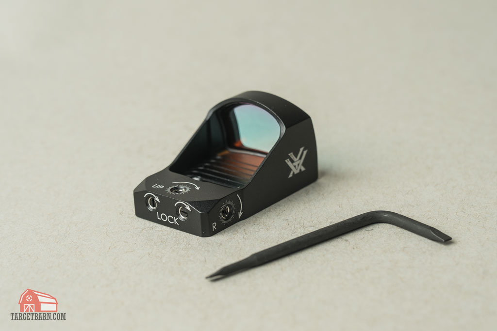 A red dot optic with adjustment tool