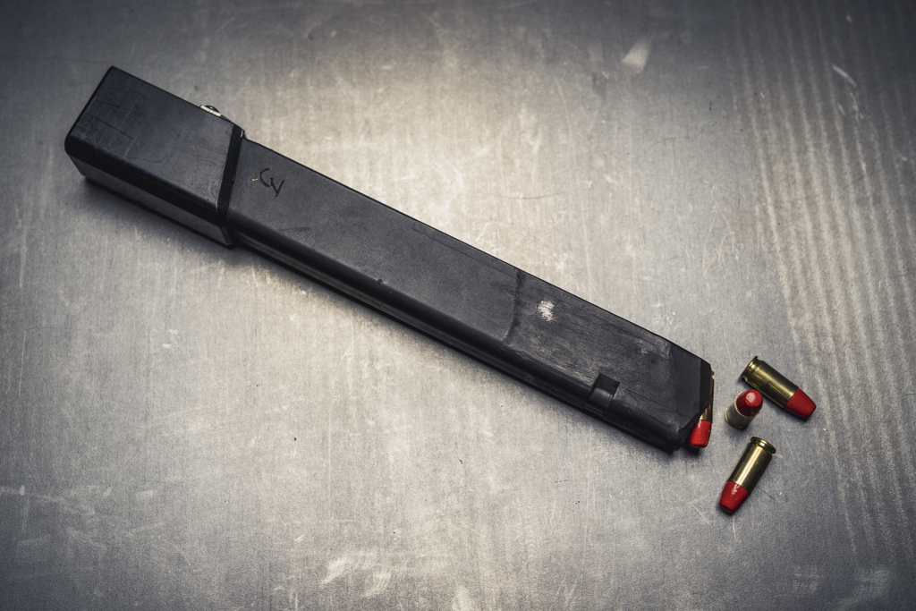a Glock magazine loaded with Federal Syntech ammo and with a base pad to add magazine capacity for PCC