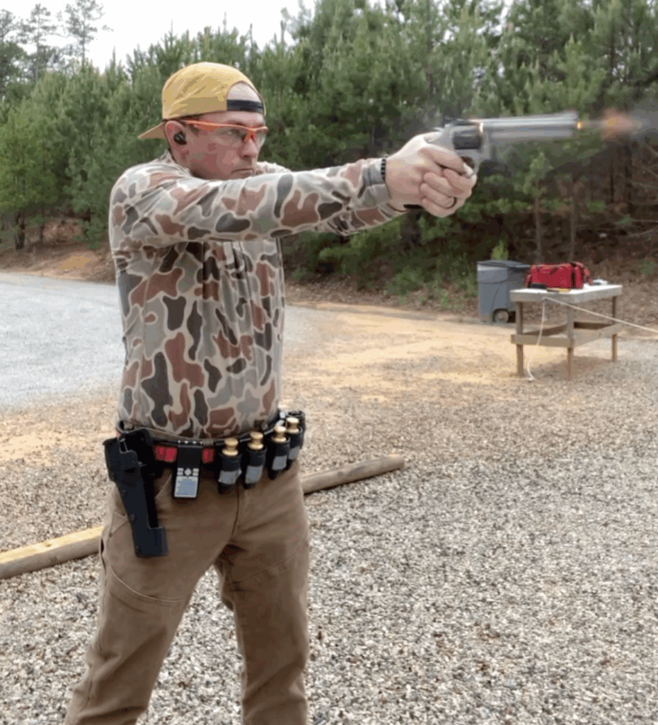 Caleb, the author, shooting the Bill Drill at a gun range.