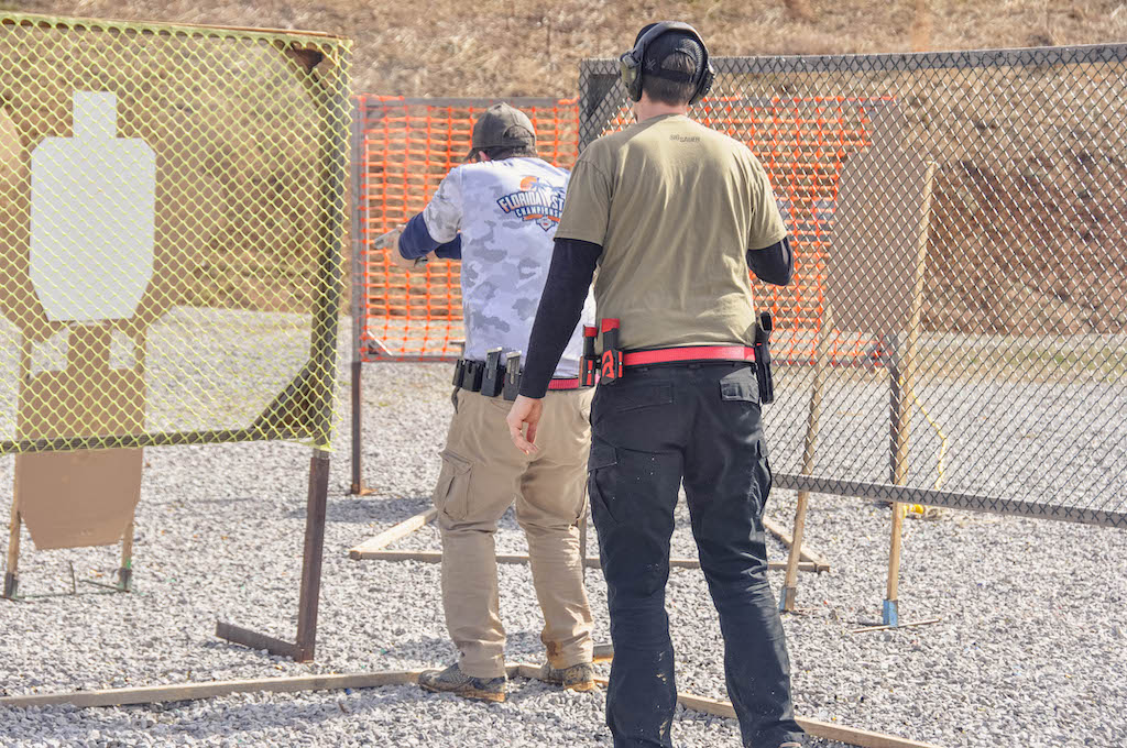 a USPSA shooter shooting a USPSA target in competition