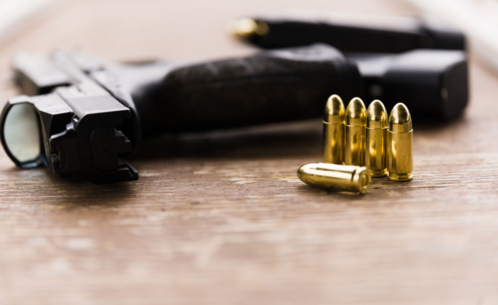 Full Metal Jacket 9mm ammo and a pistol with a red dot reflex sight