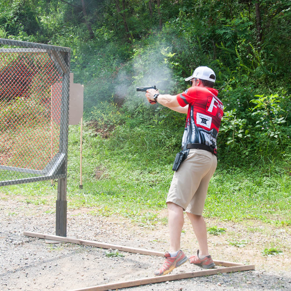 shooter in uspsa limited division shooting a stage