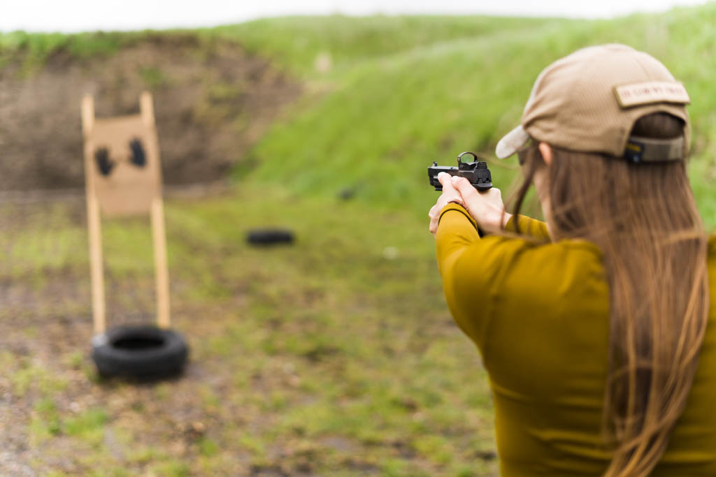 the author Emily shooting a pistol at a target with FMJ ammo