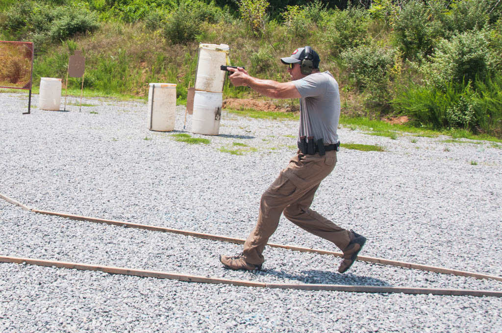 shooter in uspsa production division shooting a stage