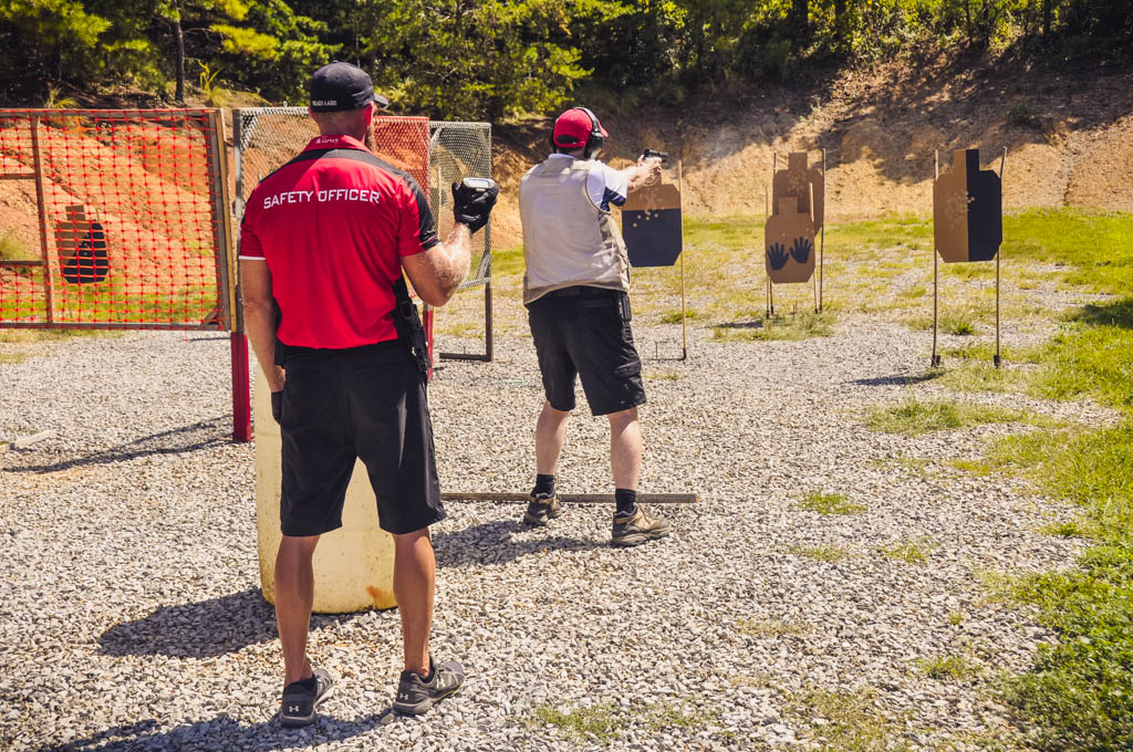 a range officer running an idpa shooter through a stage