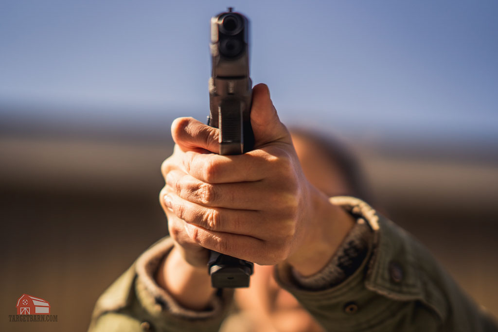 tip of the trigger finger pushing a glock to the left