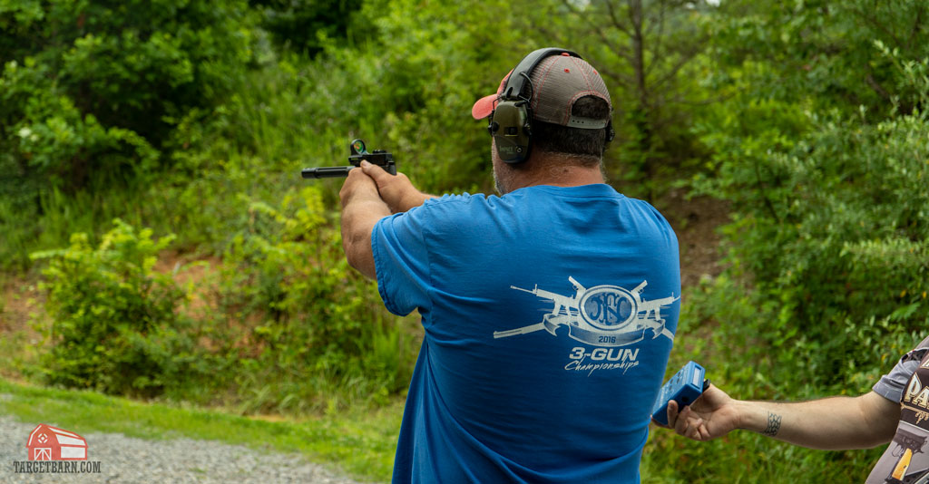 a competitor shooting in the rimfire pistol open steel challenge division