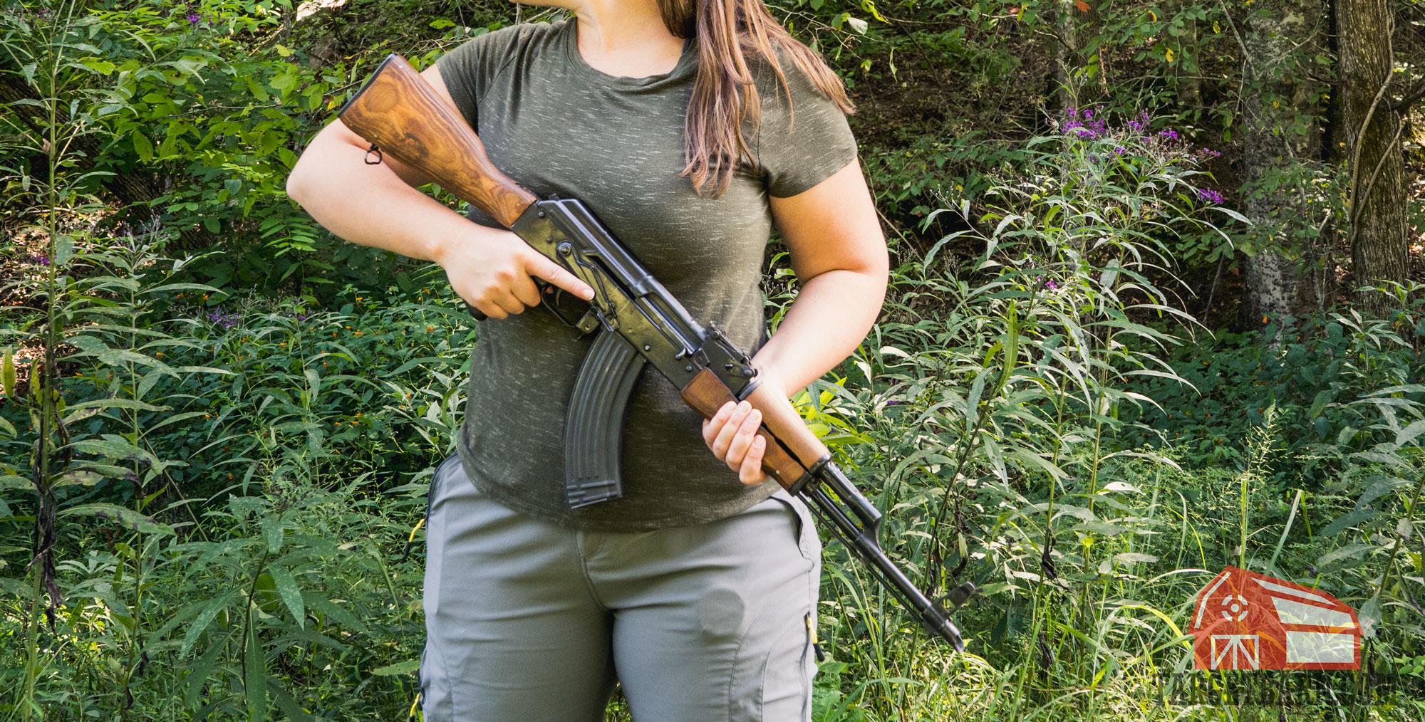 a woman holding an ak-47 rifle