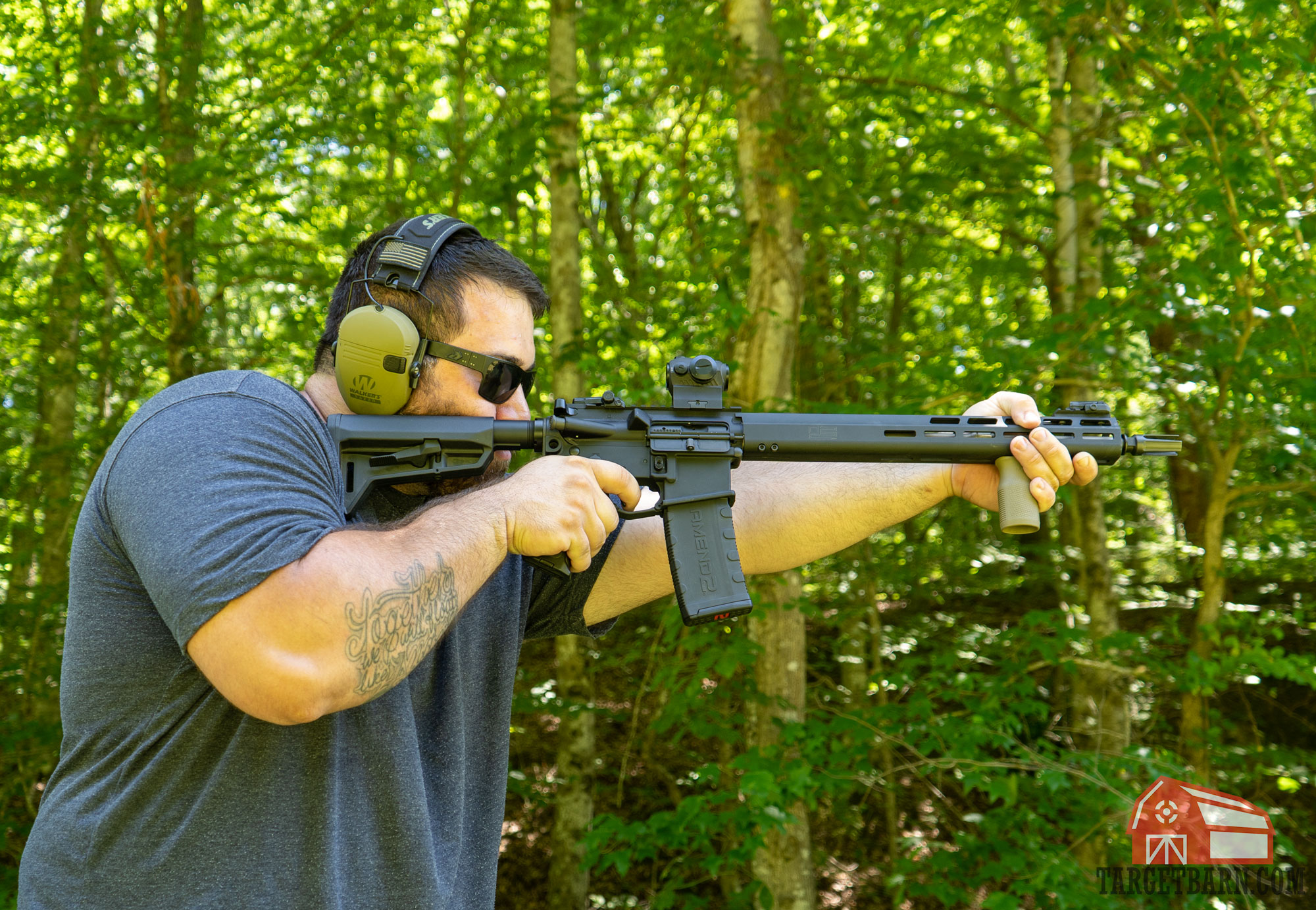 a man shooting a sig sauer ar-15 at the range