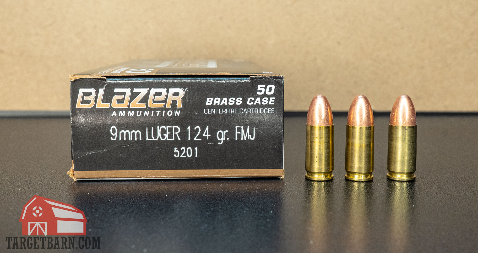 a box and three rounds of 9mm blazer brass 124gr. fmj