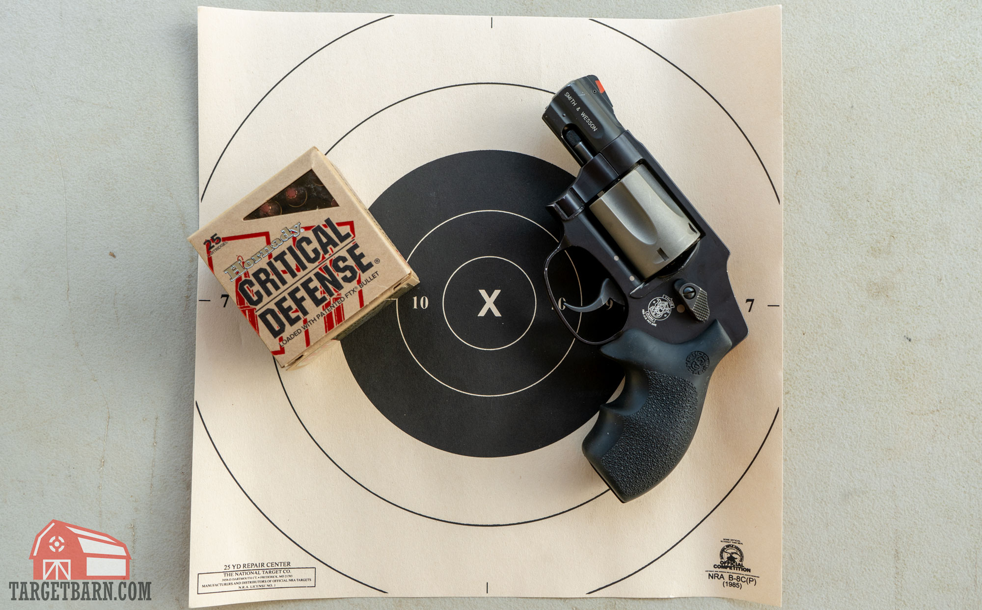 a box of critical defense 38 special and a smith & wesson 342 pd on a target