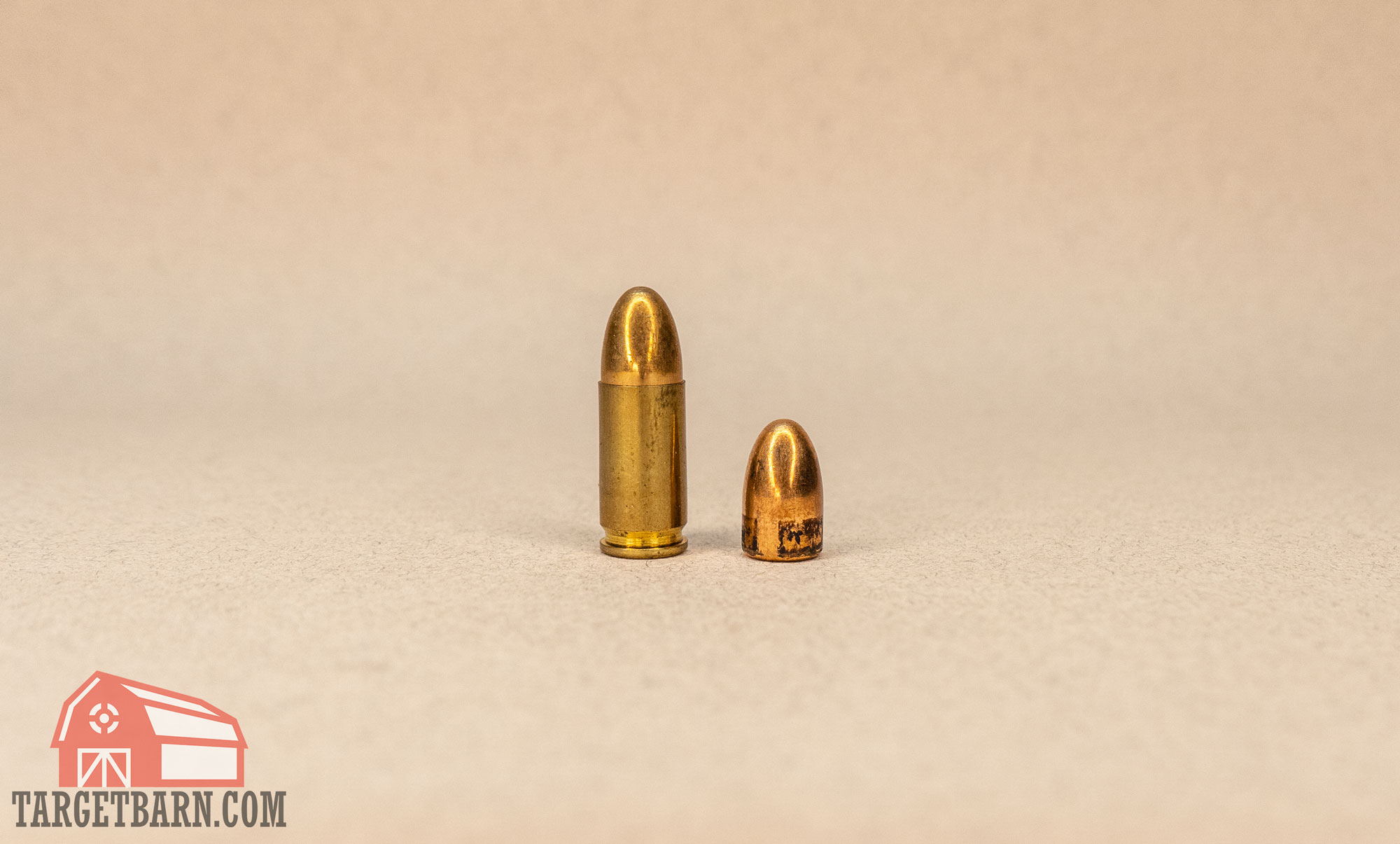 a 9mm cartridge next to a 9mm bullet