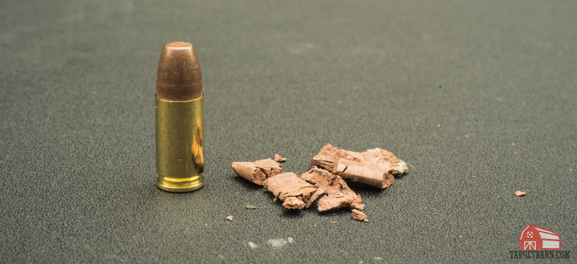 a frangible round next to a shattered frangible bullet