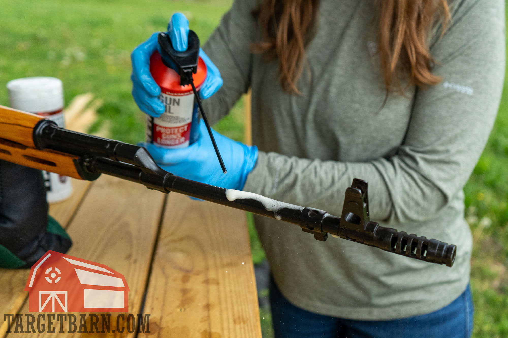 applying gun oil to barrel