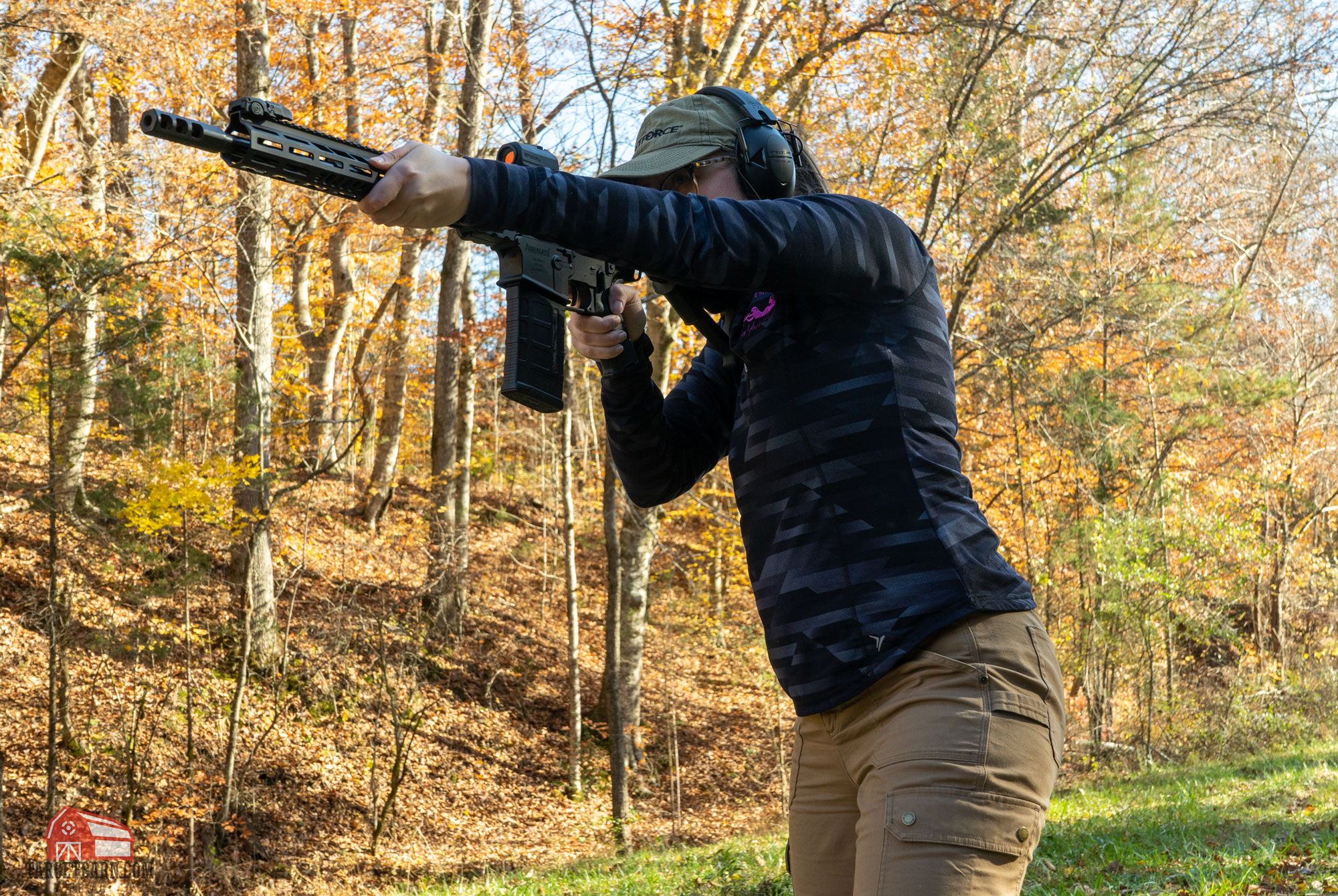 the author wearing proper range attire while shooting a rifle at the range