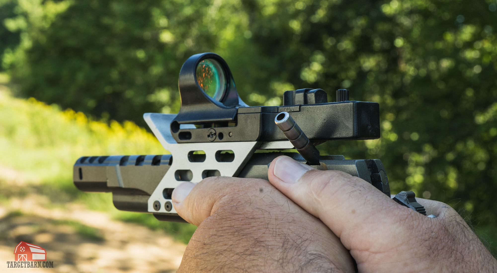 a c-more red dot sight mounted on a race gun for uspsa open