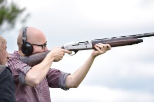 Man shooting shotgun