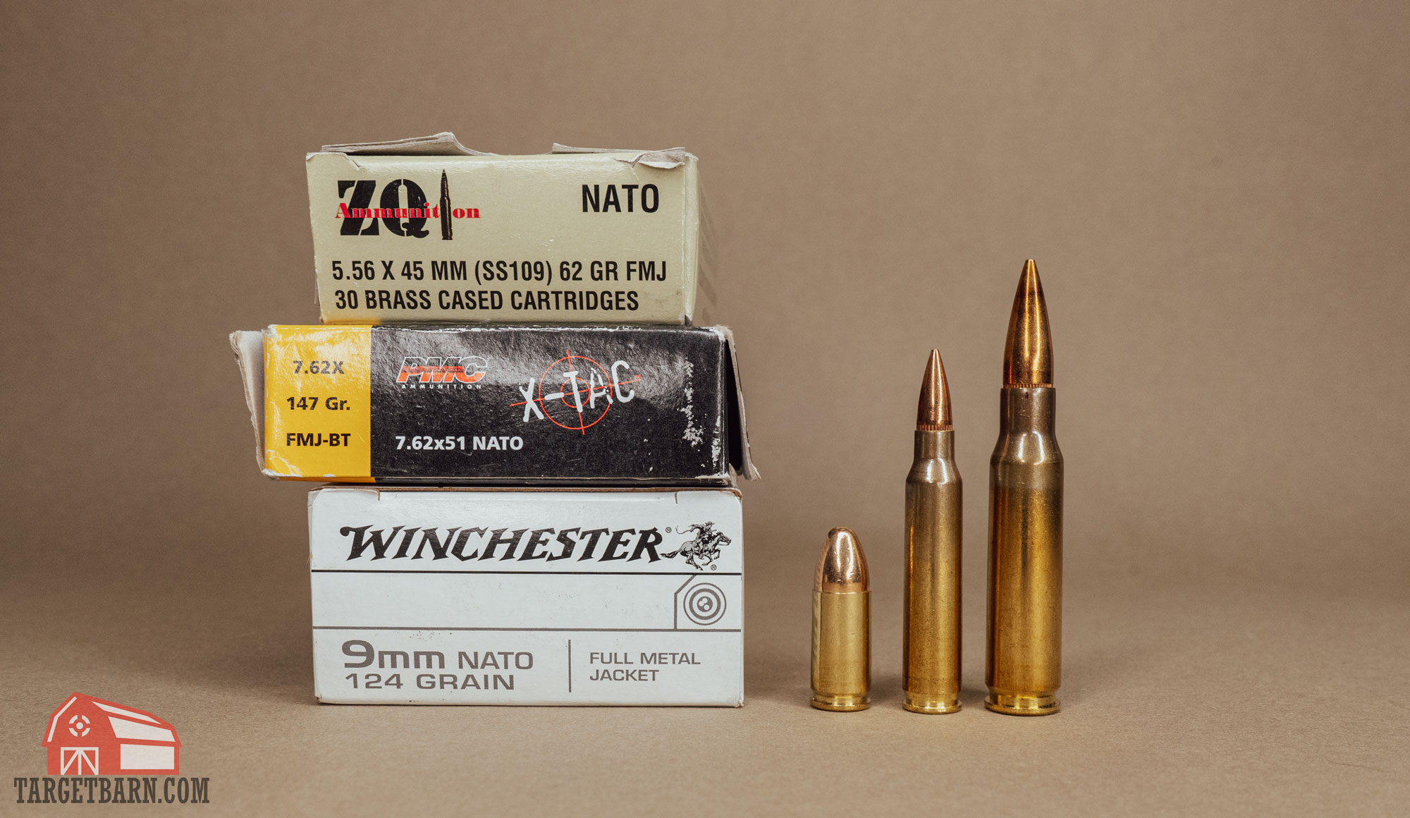 three boxes of nato ammo, including 5.56, 9mm, and 7.62 next to three rounds of nato ammo