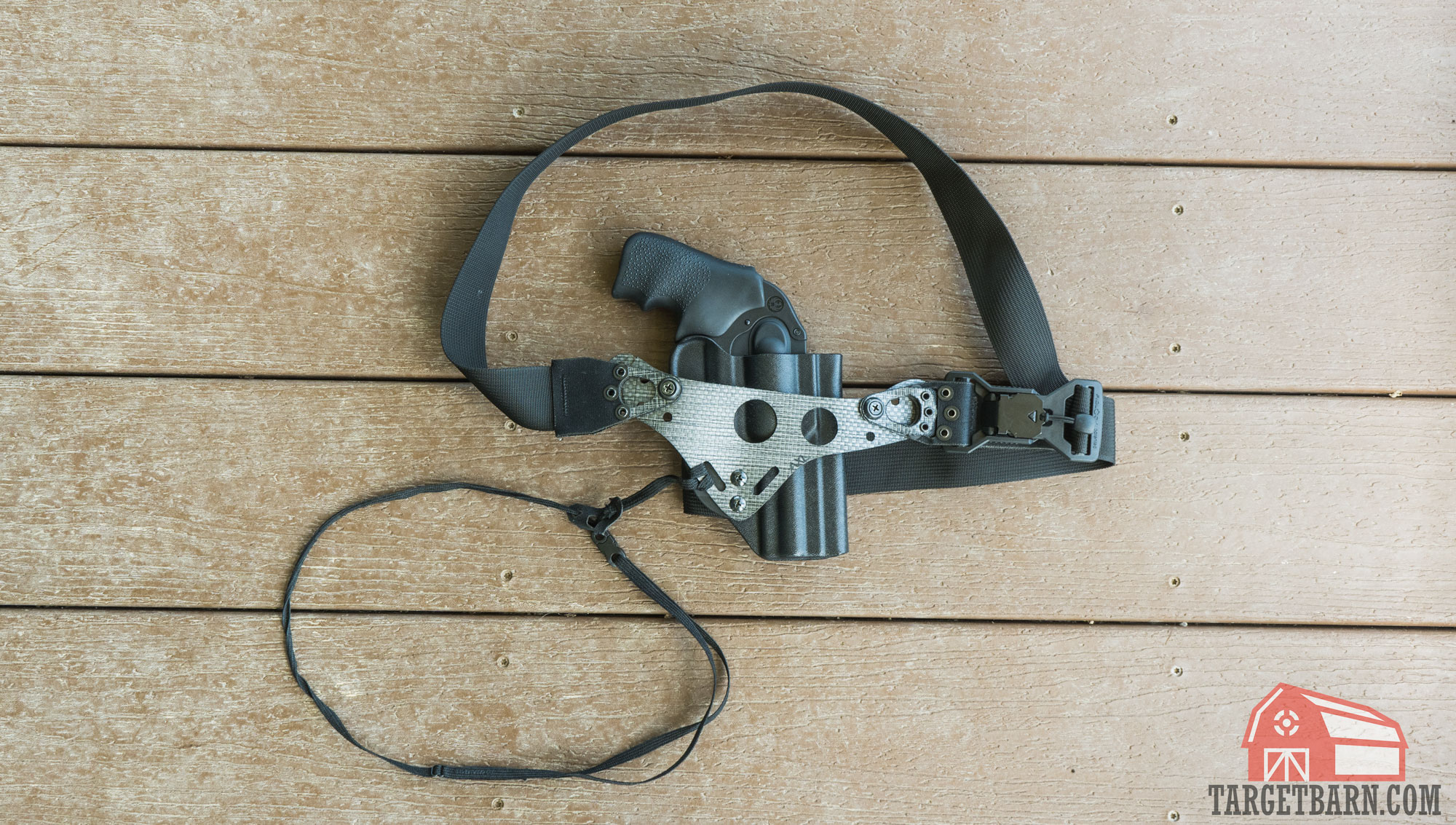 the phlster enigma holster system laying flat on the ground with a revolver holstered