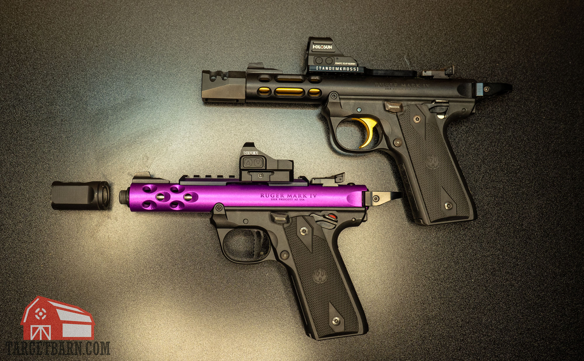two .22lrr pistols, one with a compensator attached and one with the compensator detached 