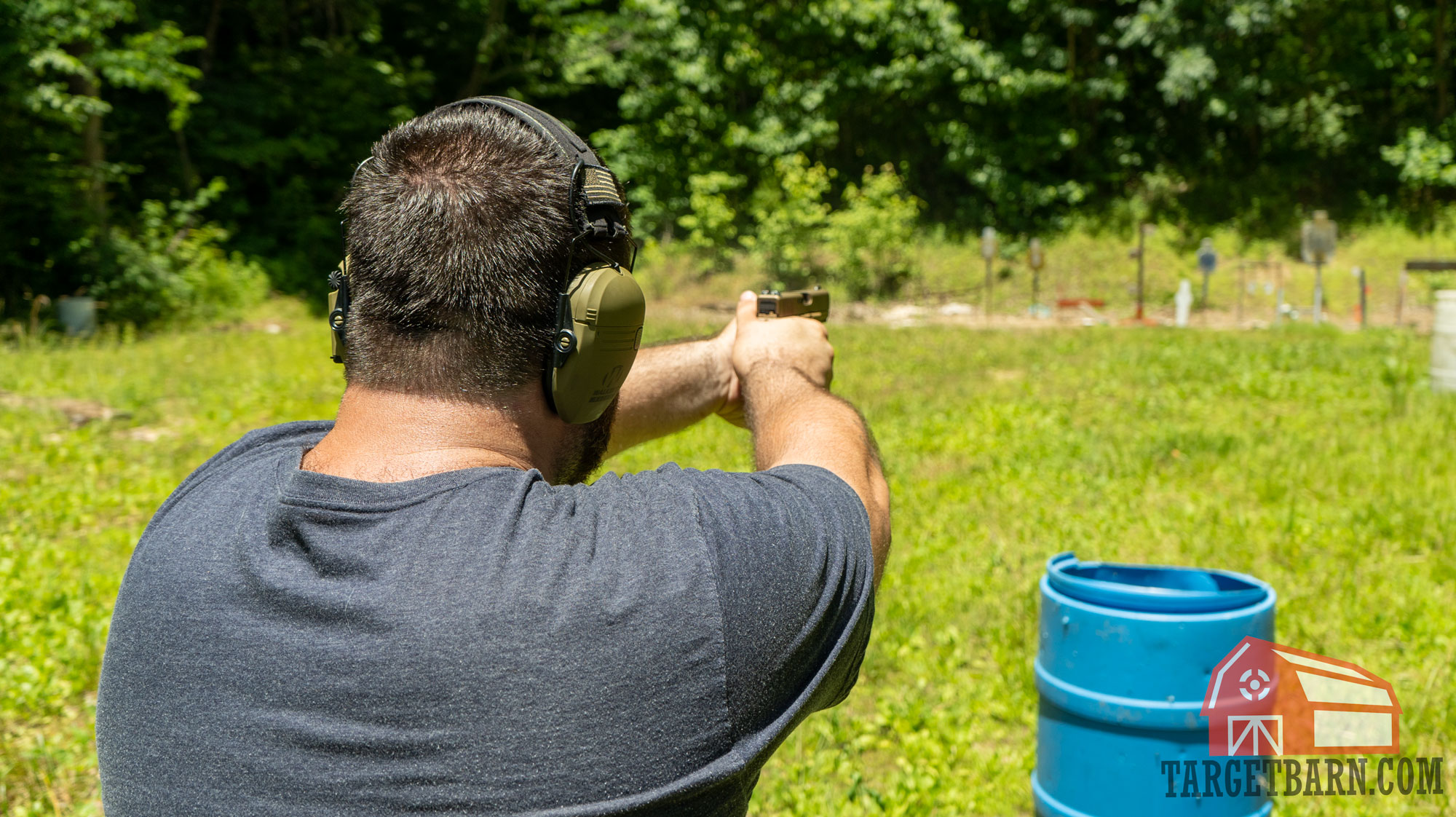 a man shooting a glock pistol at the range