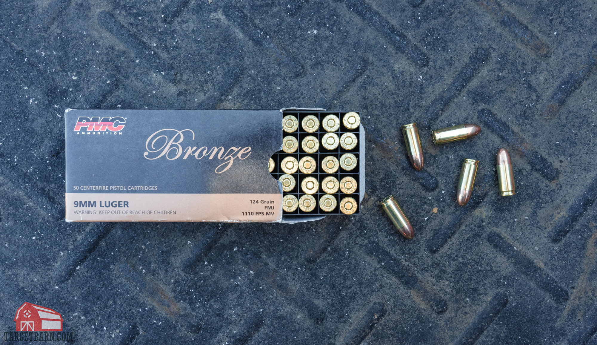 an open box of pmc bronze 9mm ammo