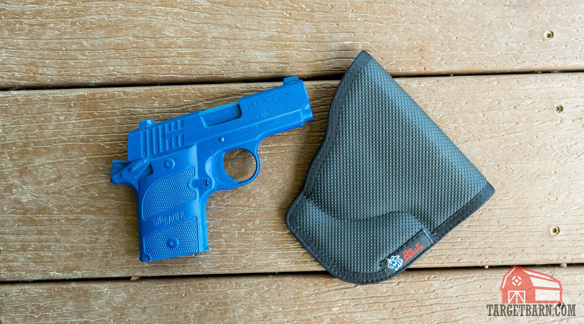 a blue gun next to a pocket holster