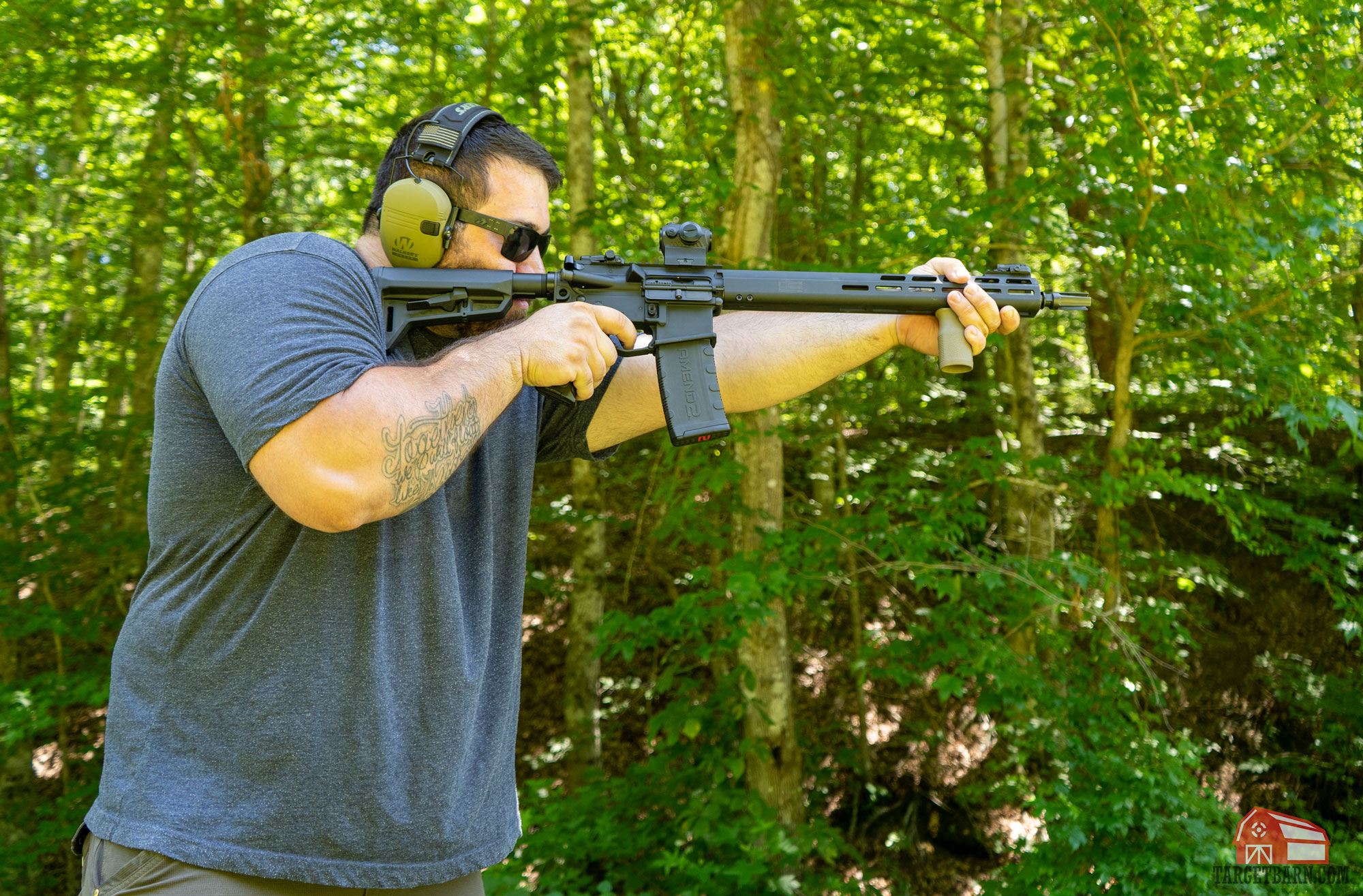 a man shooting one an ar-15 semi-automatic rifle