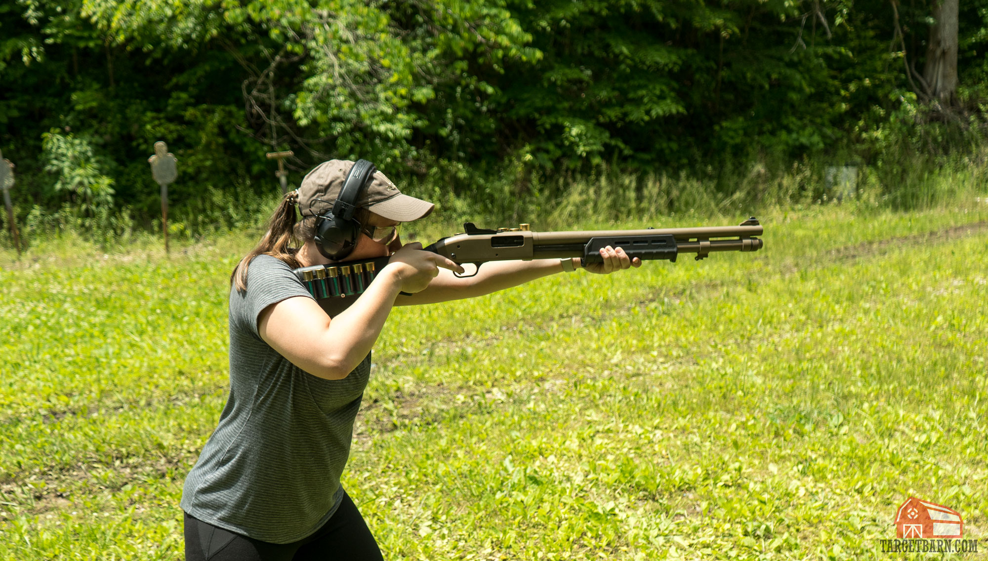 mckenzie shooting a shotgun with extra shells carried on a shotgun butt cuff