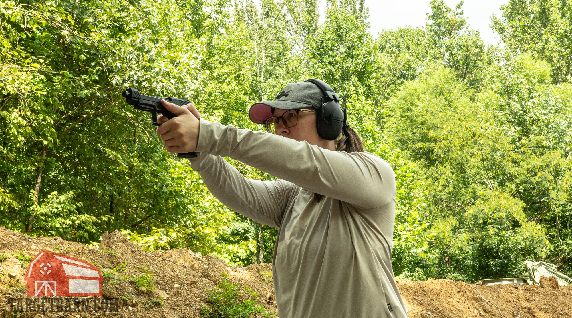 shooting .22lr the author shooing a taurustx 22 pistol at the range to find the best .22lr ammo for pistols