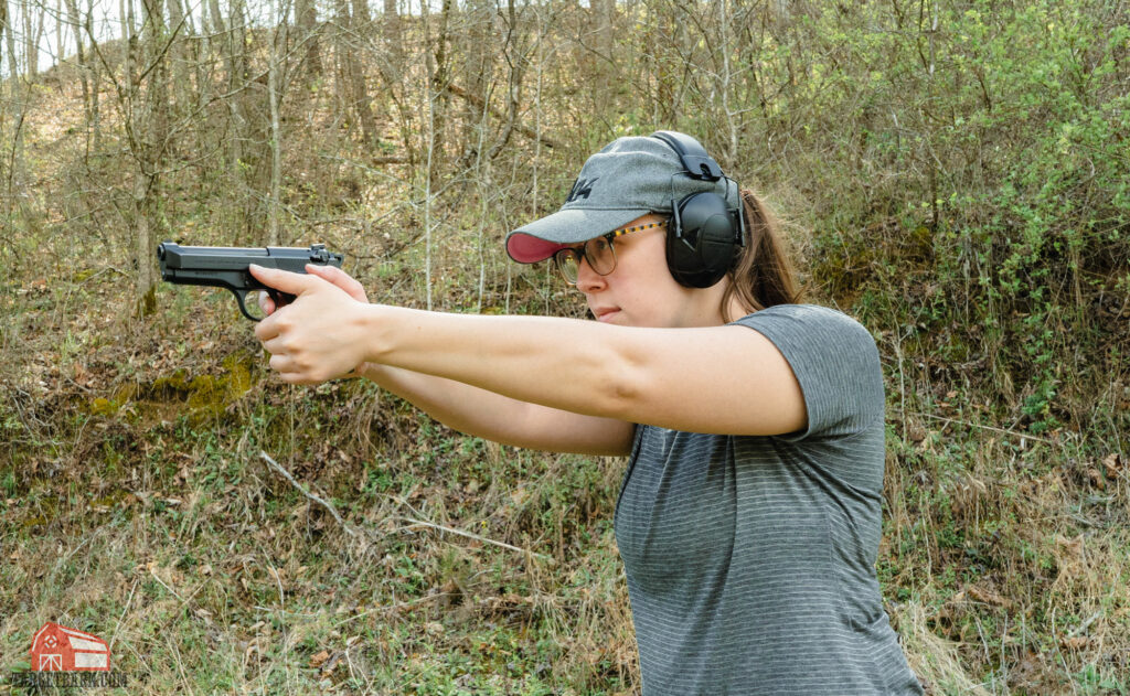 the author shooting a beretta pistol at the range