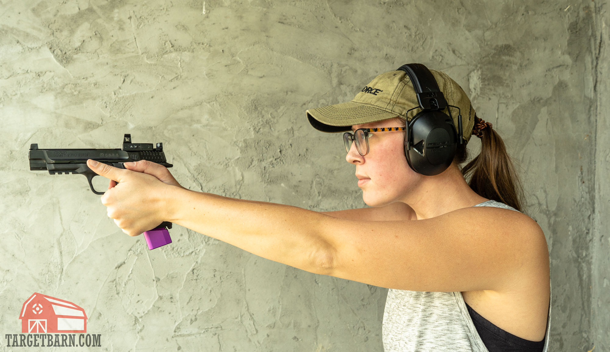 a woman shooting a 9mm pistol 