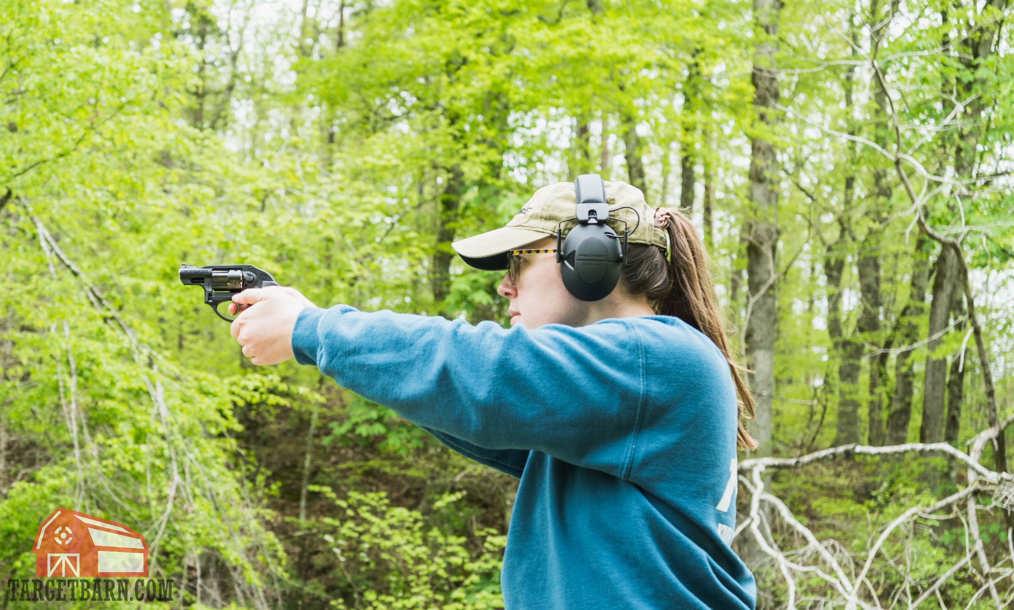 a woman shooting a revolver
