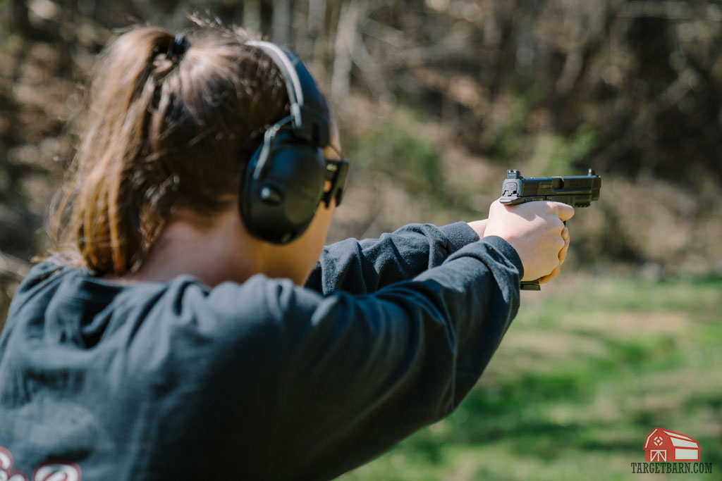 the author shooting a striker fired pistol 