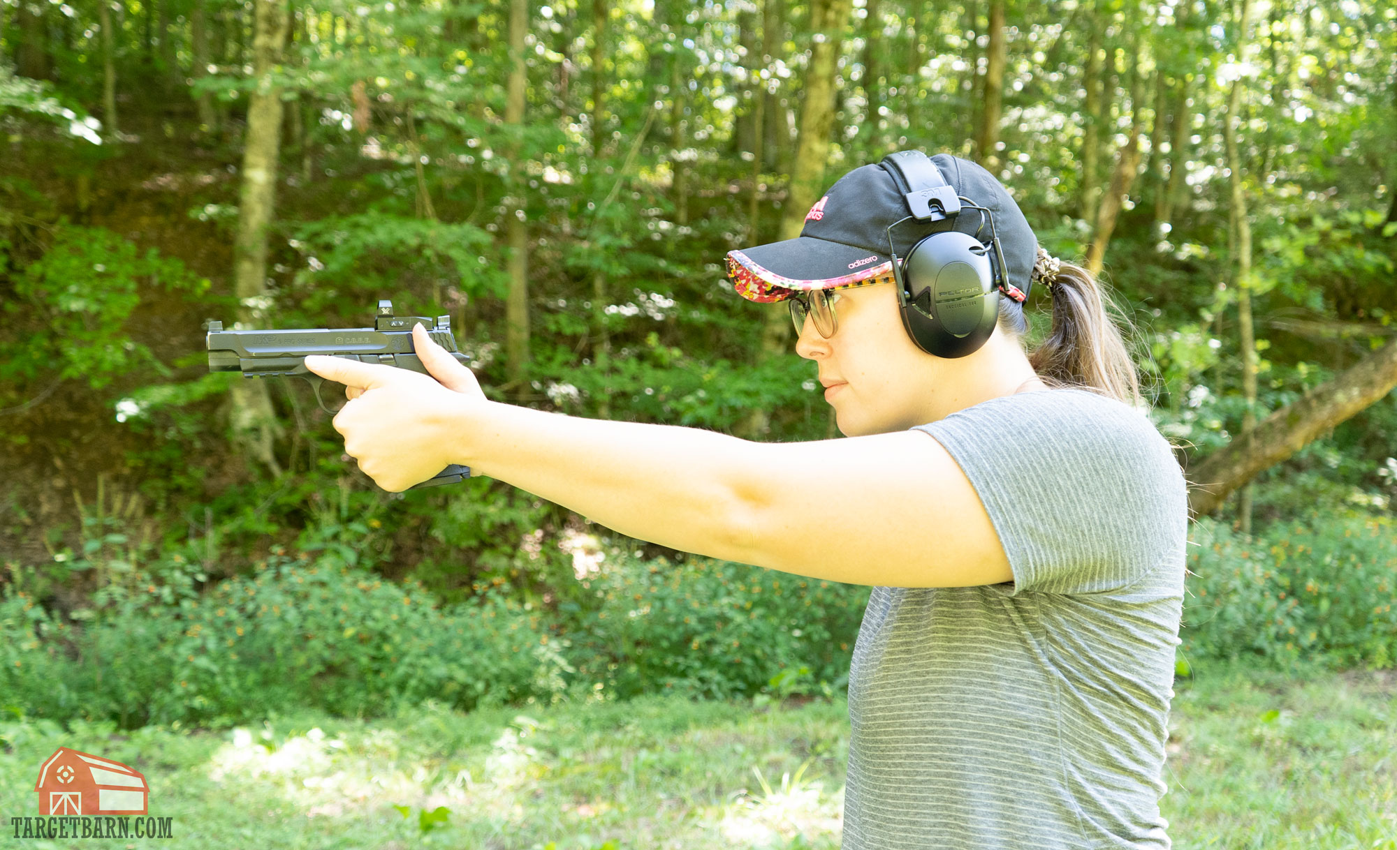 the author shooting a vortex venom mounted on a smith & wesson m&p core at the range