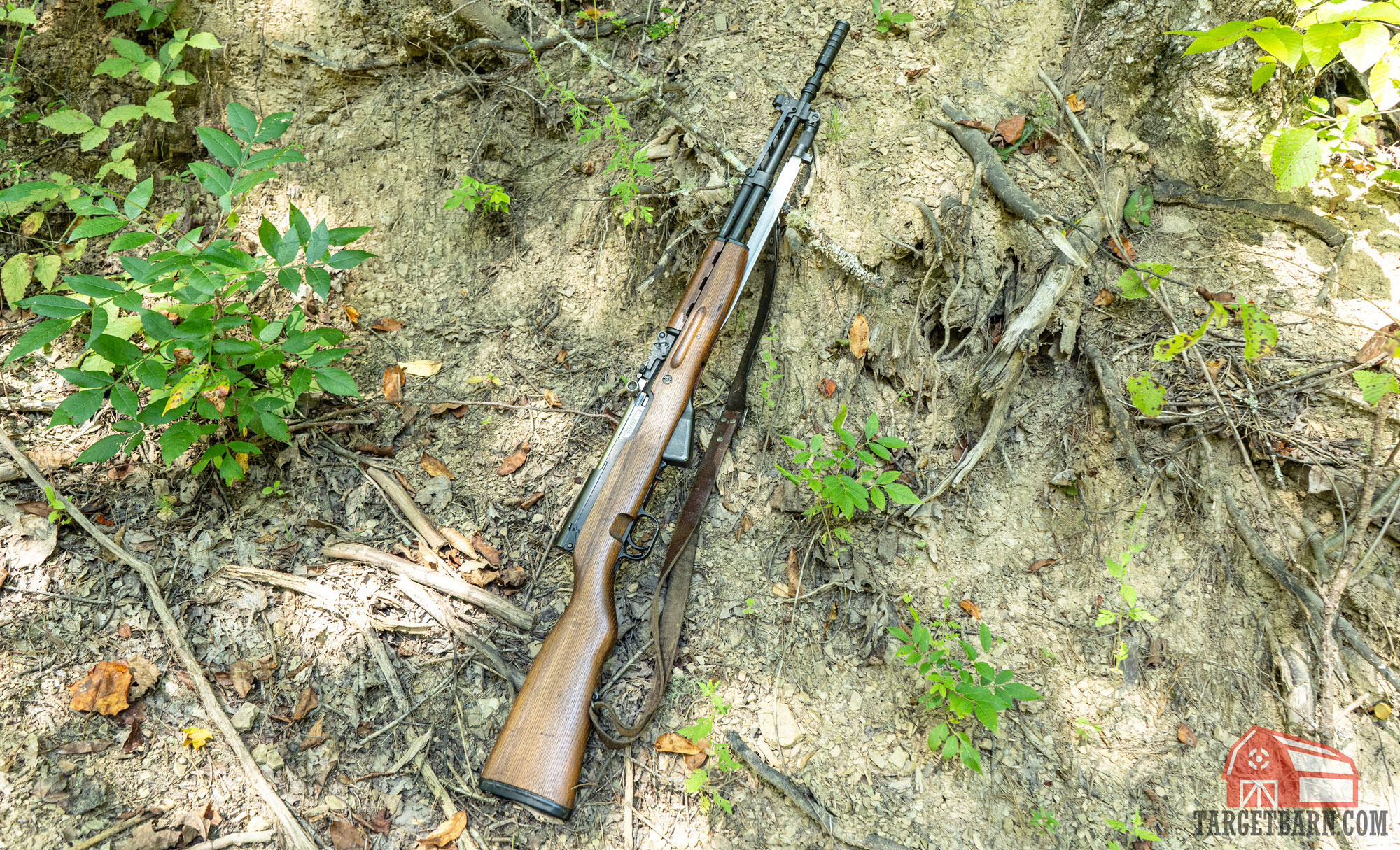 an sks sitting against a hillside