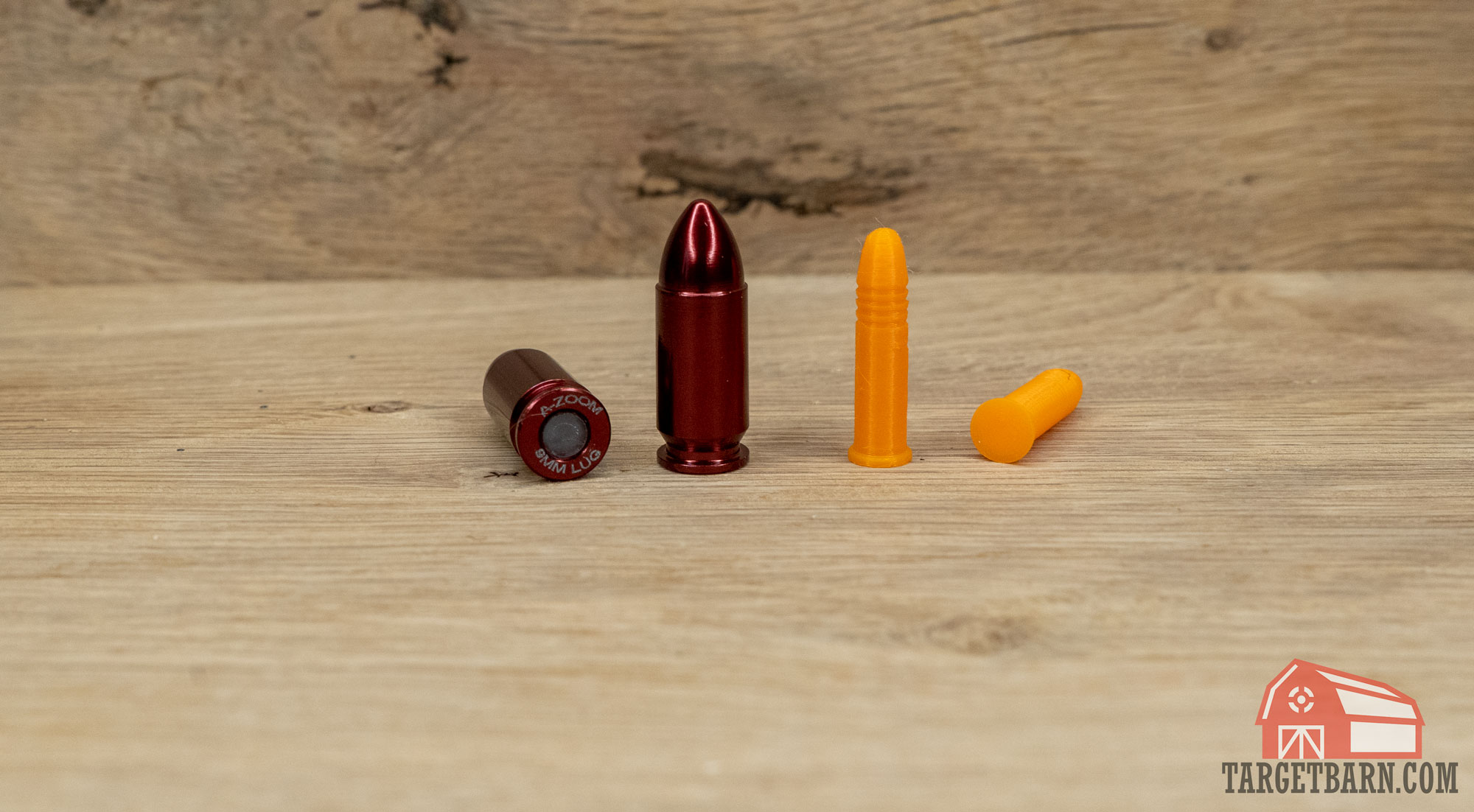 two snap caps next to two dummy rounds showing the base of each