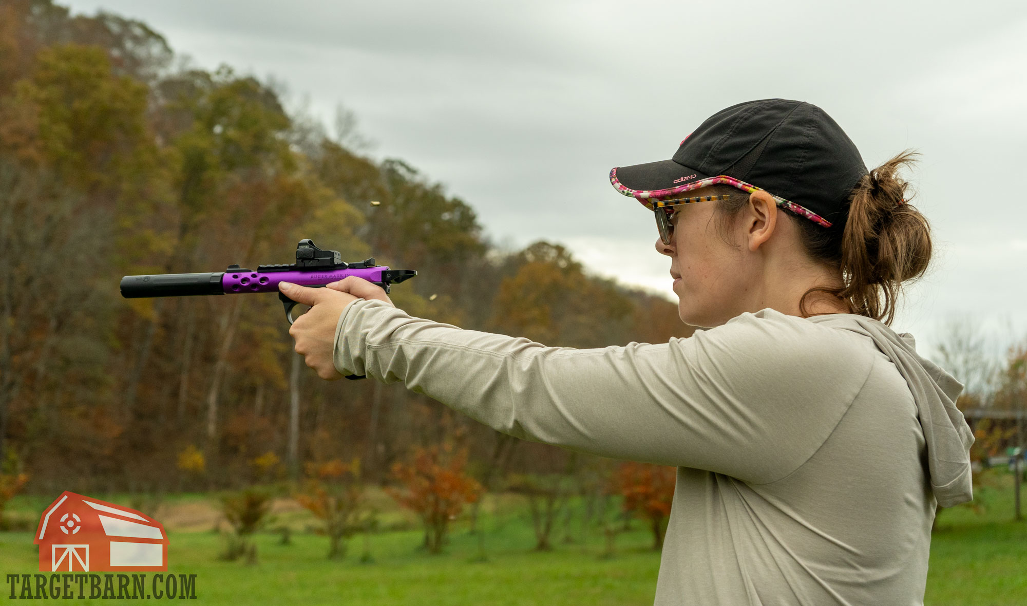 suppressed 22lr a woman shooting a ruger mark iv lite pistol with a suppressor at the range